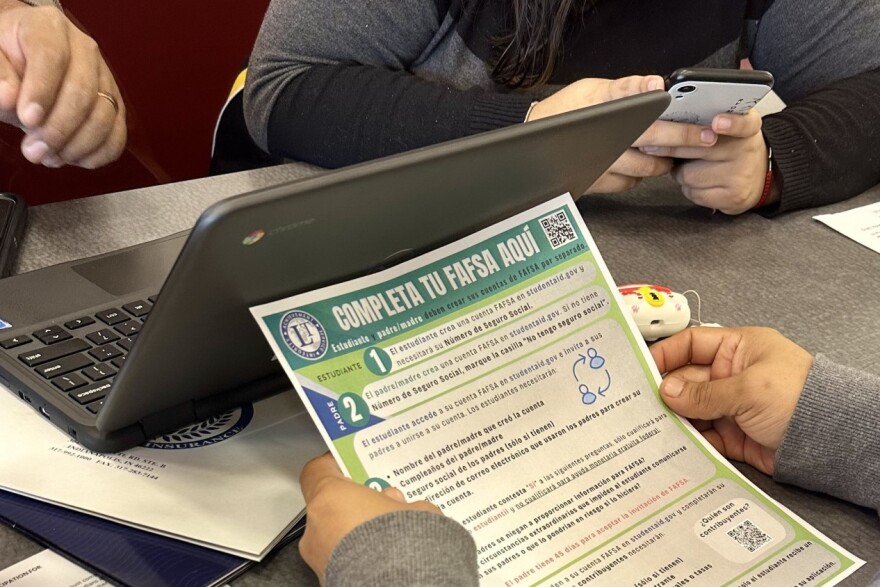 A family works on completing the FAFSA form at Lawrence Central High School on Wednesday, April 3, 2024.