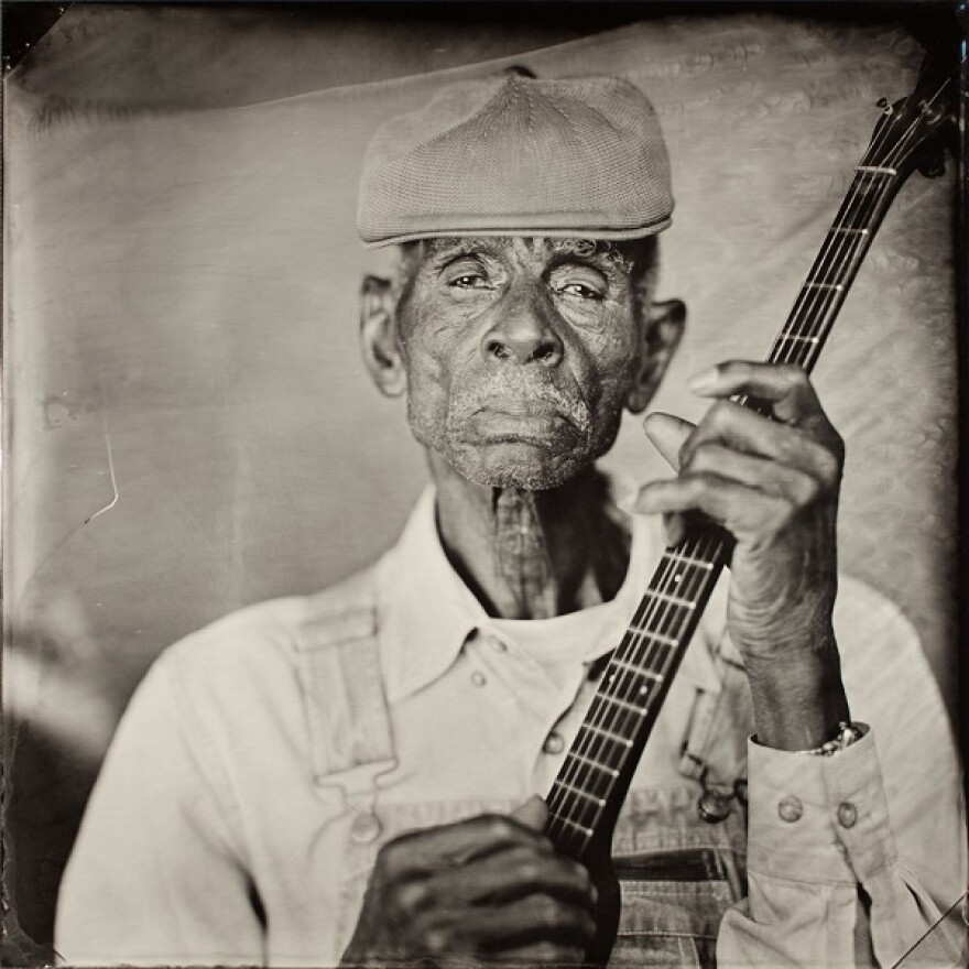 John Dee Holeman holds a bajo given to him by his uncle. He plays a style of music that was once thought to be lost, according to Timothy Duffy in his book,  "Blue Muse: Timothy Duffy's Southern Photographs."