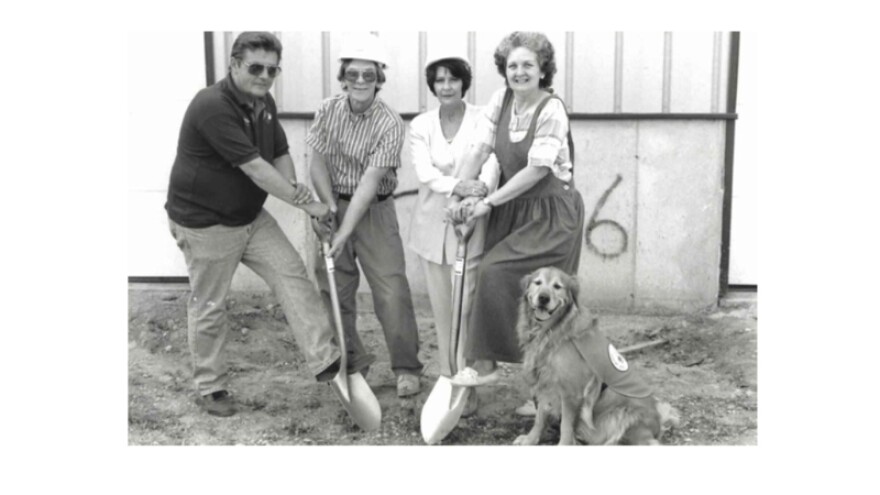 Mike and Candye break ground on the first PAWS building alongside the organization’s first clients, Marty and Diane.