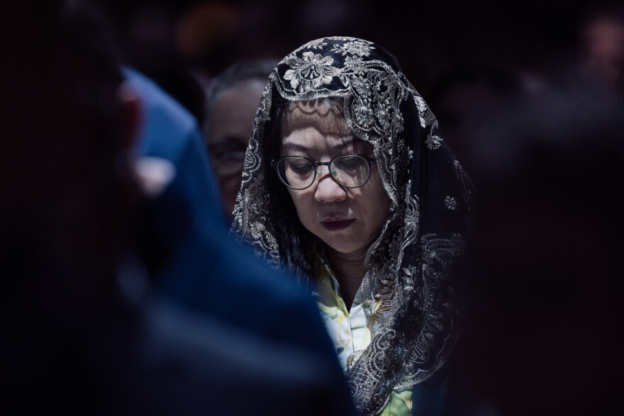 A woman wearing a lace mantilla prays during the beatification Mass for the late Archbishop Fulton J. Sheen on Thursday.