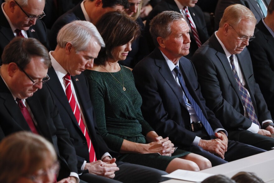 Former Ohio Governors John Kasich (R) and Ted Strickland (D) attend Gov. Mike DeWine's inauguration ceremony.