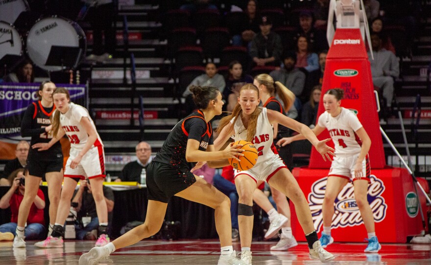 Girls high school basketball players inside an arena