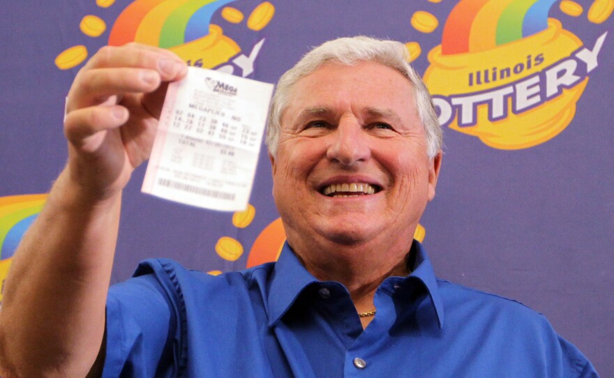 Merle Butler shows off his winning Mega Millions Quick Pick ticket that netted him nearly $111 million (after taxes) during a press conference in Red Bud, Ill. on April 18, 2012. Butler is a retired computer analyist from Red Bud.