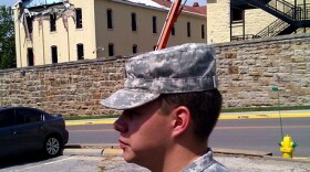 Army medic PVT Jeremy Warren of Liberty, MO. helped free man buried by falling brick and concrete. (site in left background at Ft. Leavenworth) Click to enlarge.