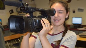 Cooper High School student Elly Galvan is holding the video camera.