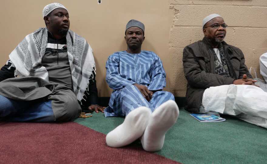 Rafiu Aremu (center) sits alongside others at a Nigerian mosque just outside D.C. Aremu wonders whether the real purpose behind the travel ban is to reduce the inflow of immigrants from Africa to the U.S.