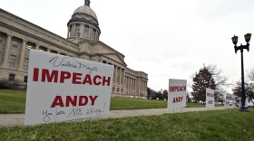 Signs, some with personal messages promoting the impeachment of Kentucky Governor Andy Beshear, line the walkway and lawn of the State Capitol building in Frankfort, Ky., Tuesday, Jan. 5, 2021.