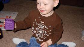 Caleb Hisle plays with colored blocks as part of the HANDS program for first-time parents. The program teaches parents how to interact and bond with their children.