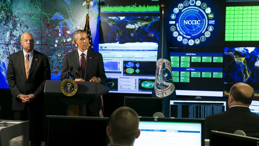 President Obama, joined by Homeland Security Secretary Jeh Johnson (left), delivers remarks at the National Cybersecurity and Communications Integration Center on Jan. 13 in Arlington, Va. Obama discussed efforts to improve the government's ability to collaborate with industry to combat cyber threats.