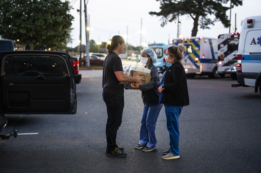 Kyle Fehrenbach, a sound engineer who was laid off from multiple jobs with the shutdown of bars and restaurants nationwide, delivers ready-to-eat meals for over-worked medical staff at Oschner Medical Center West Bank.