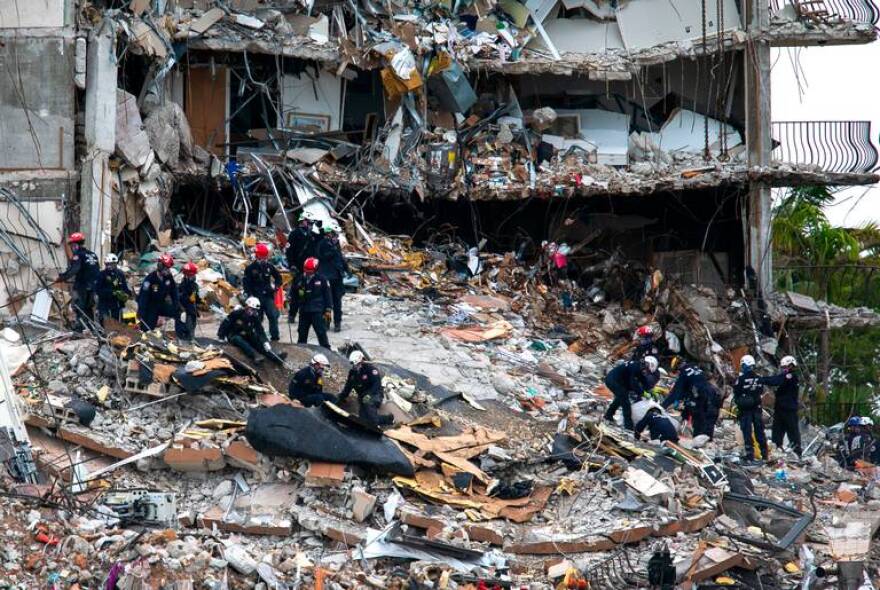 The South Florida Urban Search and Rescue team looks through rubble for survivors at the partially collapsed Champlain Towers South condo building in Surfside, Florida, on Monday, June 28, 2021.