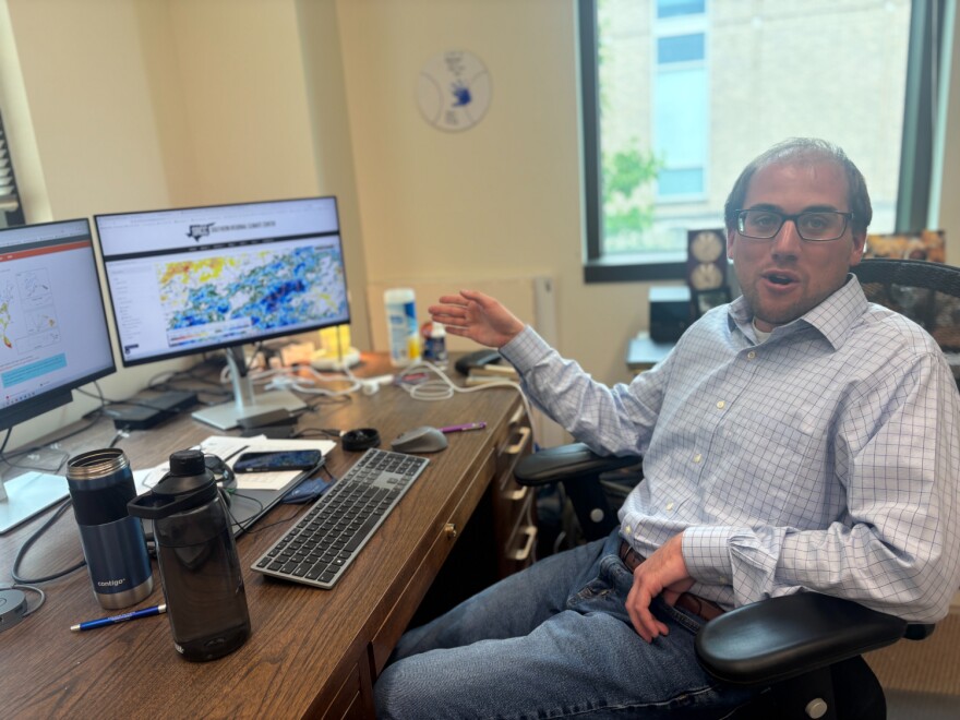 Missouri State Climatologist Zack Leasor examines weather reports to assess drought from his office in Columbia, Missouri.