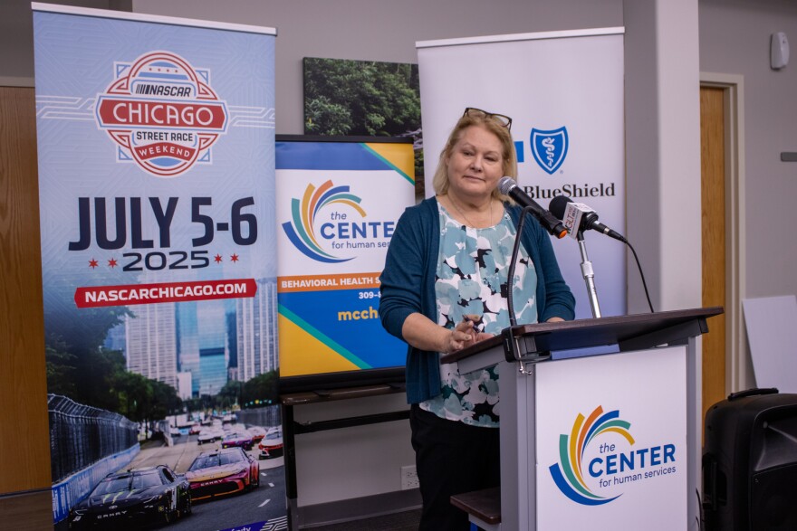 A woman stands at a podium
