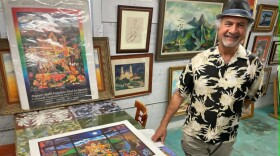 Artist Hal Marcus with prints of his "El Paso Gracias a Dios" painting that was displayed at the Chamizal National Memorial for more than 30 years.