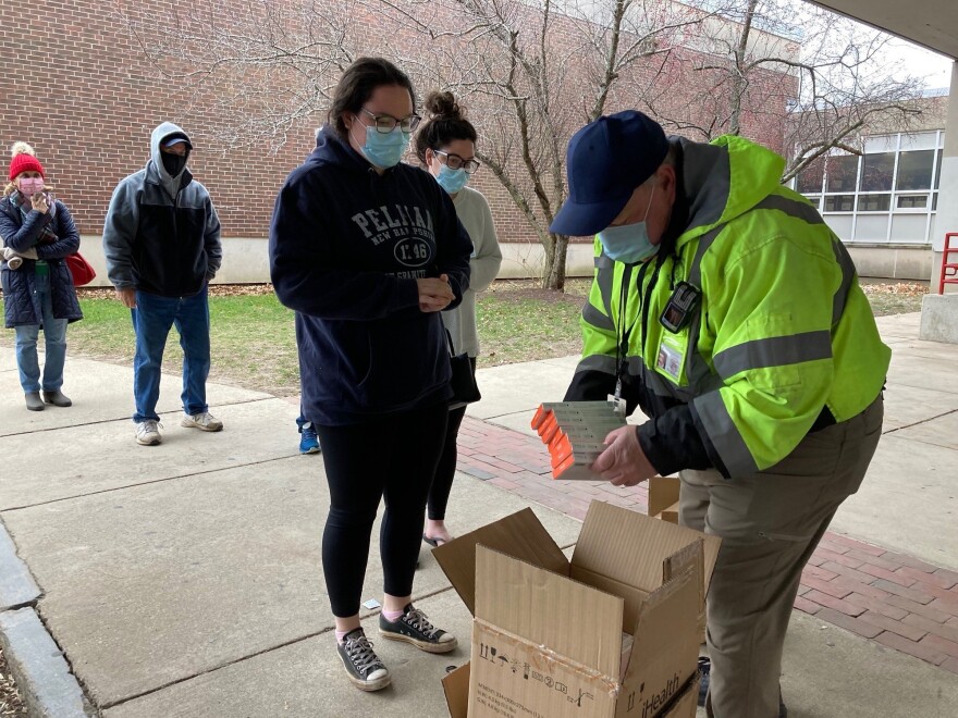 Don Murphy hands out free rapid COVID tests outside of Robinson Middle School in Lowell, Massachusetts.