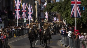 Members of the armed forces ride horses during a parade rehearsal, ahead of Prince Harry and Meghan Markle's wedding in Windsor, England, Thursday, May 17, 2018. Preparations continue in Windsor ahead of the royal wedding of Britain's Prince Harry and Meghan Markle Saturday May 19. (AP Photo/Emilio Morenatti)