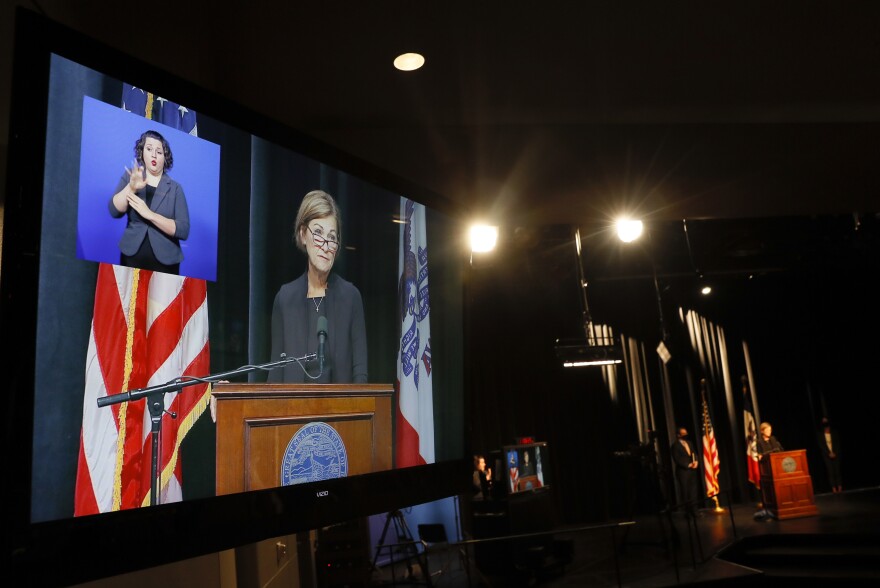 Iowa Gov. Kim Reynolds is seen on a monitor as she updates the state's response to the coronavirus outbreak during a news conference, Tuesday, Aug. 4, 2020, in Johnston.