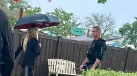 County Mayor Sara Baxter walks toward a Palm Beach County sheriff’s sergeant as she enters pet rescue