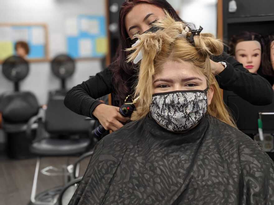  Johnston County Community College cosmetology student Rocio De Leon gets her hair curled during the class's salon hours.