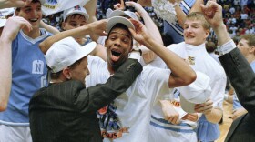 In this file photo from 1991, North Carolina's Hubert Davis celebrates on the court with teammates after the Tar Heels defeated Temple 75-72 in NCAA East Regional championship game at the Meadowlands in East Rutherford, N.J. on Sunday, March 24, 1991. According to multiple reports, Davis is the new head coach of the Tar Heels.
