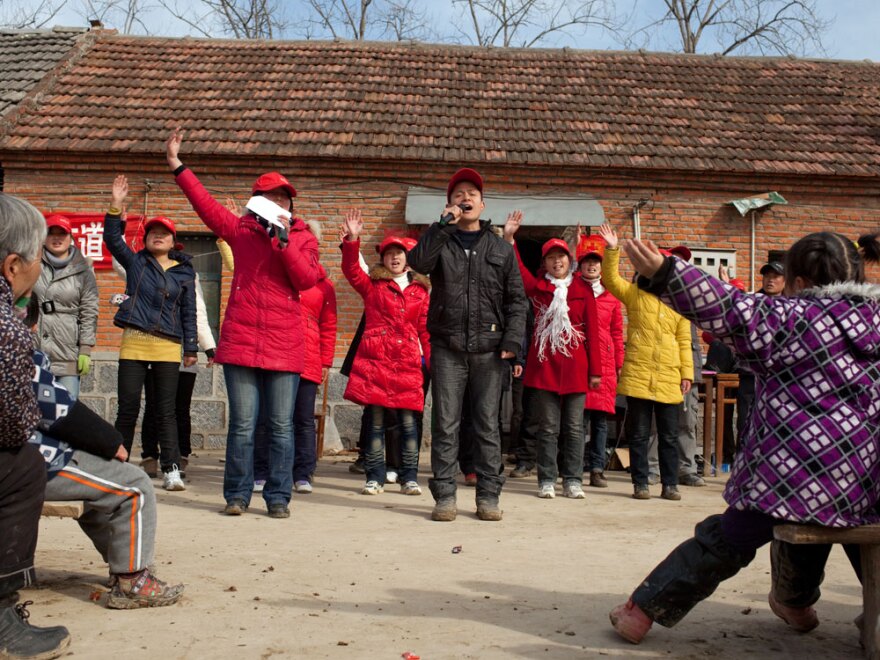 A group of young Christians preaches on the streets in a rural Chinese village. China's constitution protects freedom of religion but prohibits proselytizing in public places.