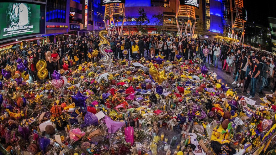 Lakers fans outside the Staples Center pay their respects, surrounding a memorial for Kobe Bryant, Gianna Bryant, and seven other victims killed last weekend in a helicopter accident.