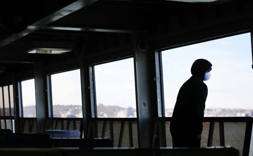 Tremaine Fredericks rides a nearly empty Staten Island Ferry to Manhattan in New York City. Gov. Andrew Cuomo's "New York State on PAUSE" executive order went into effect on March 22.