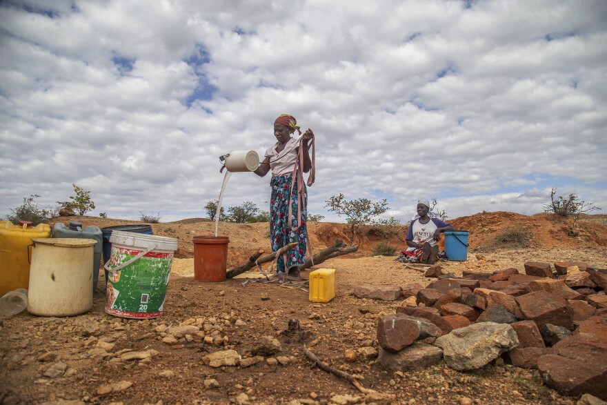 File — Villagers fetch water from a makeshift borehole in Mudzi, Zimbabwe, Tuesday, July 2, 2024. as the United Nations' food agency says months of drought in southern Africa, triggered by the El Niño weather phenomenon, has had a devastating impact on more than 27 million people and caused the region's worst hunger crisis in decades. (AP Photo/Aaron Ufumeli/File)