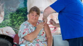 A flood survivor receives a tetanus vaccination at UK HealthCare’s mobile care unit in Hazard, Kentucky
