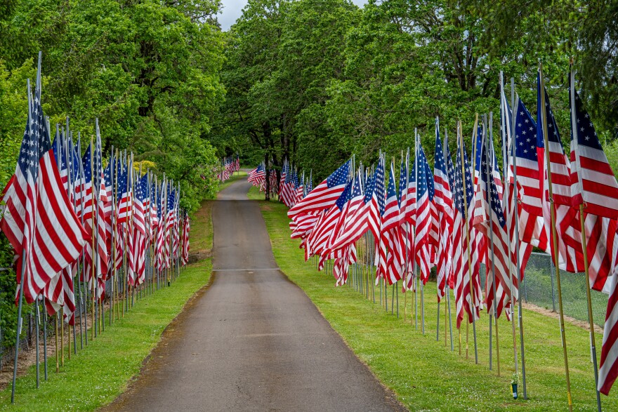 A display of United States flags on Memorial Day along a road in a cemetery near Dallas, Oregon.