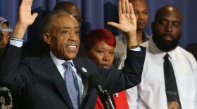 The Rev. Al Sharpton called Thursday for a federal review of racial violence and discrimination in the law enforcement community. He is flanked at the National Press Club in Washington by Lesley McSpadden and Michael Brown Sr., whose son was killed by police in Ferguson, Mo.