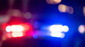 blurred photo of police car with red and blue lights at night