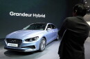 A man takes a photo of Hyundai Motor's Grandeur Hybrid vehicle during a media preview of the 2017 Seoul Motor Show in Goyang, South Korea, Thursday, March 30, 2017.