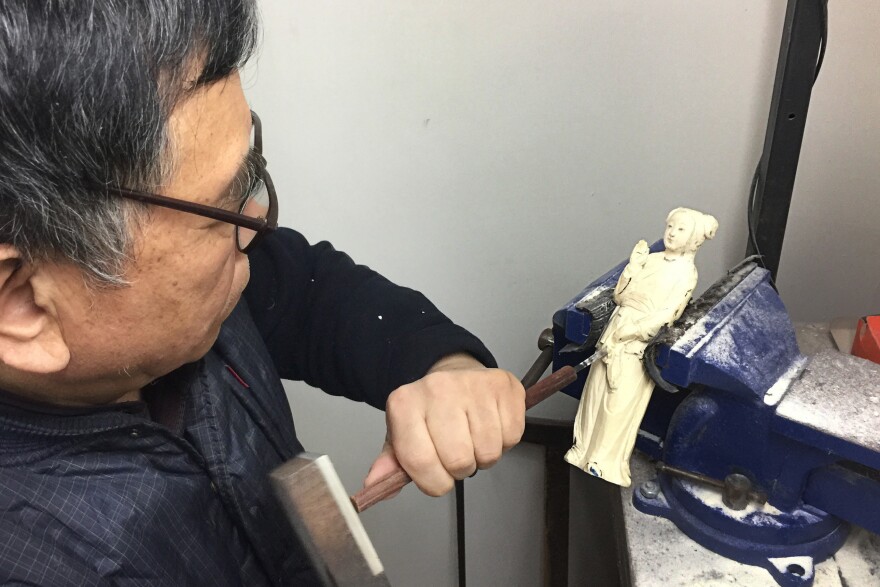 Li Chunke, a carver at the state-owned Beijing Ivory Carving factory, at work in his Beijing workshop.