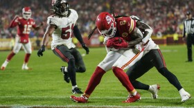 Kansas City Chiefs wide receiver DeAndre Hopkins (8) is hit in the end zone after a touchdown against Tampa Bay Buccaneers safety Josh Hayes (32) during the second half of an NFL football game, Monday, Nov. 4, 2024, in Kansas City, Mo.