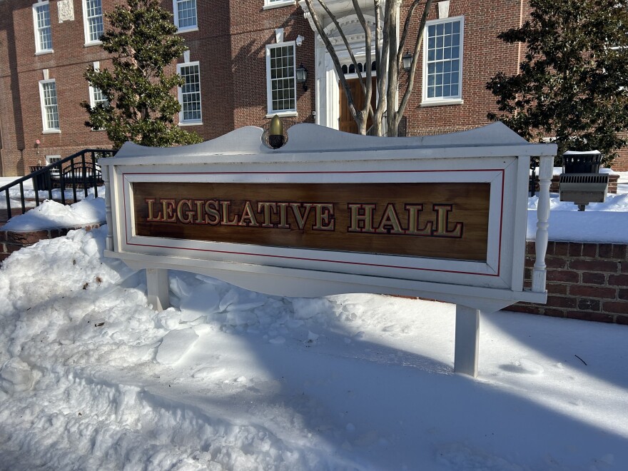 Image outside of Delaware's Legislative Hall in Dover during the winter. Sign surrounded by snow reads "legislative hall."
