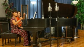 Pianists Dr. Po Sim Head (left) and Dr. Kowoon Lee take to the piano for their KPR in-studio performance.
