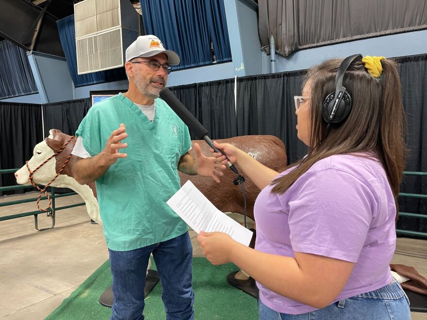 KOSU reporter Xcaret Nuñez (right) interviews veterinarian and food and animal quality specialist Dr. Barry Whitworth (left) at the Oklahoma State Fair.