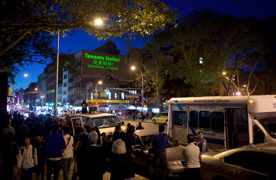 An evening projection from the Chinatown Art Brigade, in partnership with <a href="http://theilluminator.org/" target="_blank">The Illuminator</a>, at the corner of Grand and Chrystie Streets in Chinatown, New York City, in 2016. A crowd gathered to watch the projection, including local tenants, residents and passers-by.
