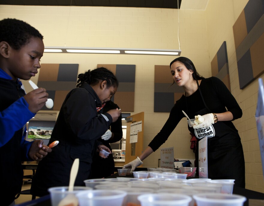 Katie Nash (right) hands out the selection of carrots for the students at Walker-Jones to sample.