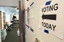 A sign directs voters to their polling location inside a library in Columbus.