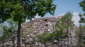 Parents and staff blame illnesses inside the Gateway school complex on debris brought over from the site of the planned National Geospatial-Intelligence Agency headquarters. The piles tower over a fence next to the school.