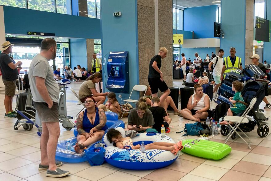 July 23, 2023: Tourists wait in the airport's departure hall as evacuations are underway due to wildfires, on the Greek island of Rhodes.