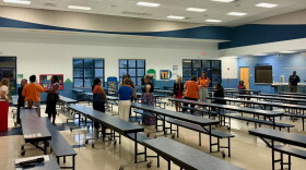Community members talk in the Oakcrest Elementary cafeteria after a meeting about the proposed Wyomina Park rezoning. Many of those in attendance were Oakcrest staff members and parents with their children.