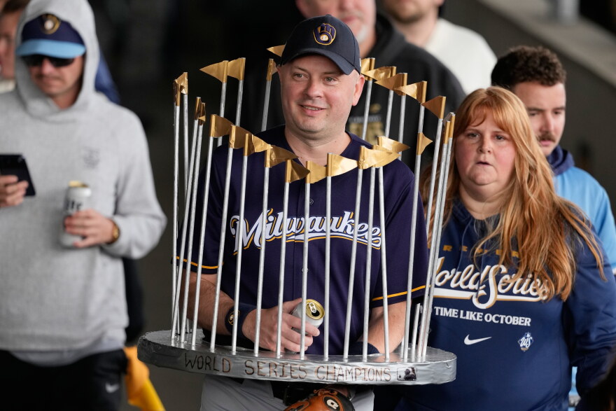 A Milwaukee Brewers fan dressed as the Commissioner's Trophy arrives for a rally during the baseball team's World Series parade, Friday, Oct. 30, 2026, in Milwaukee. (AP Photo/Nam Huh)