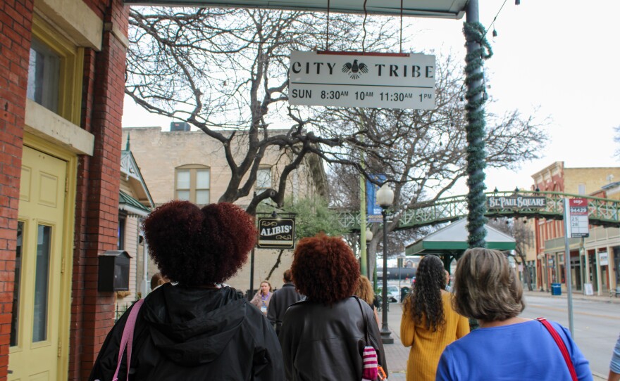 Guests follow docent Mya Jarmon around St. Paul Square during the Green Book tour.