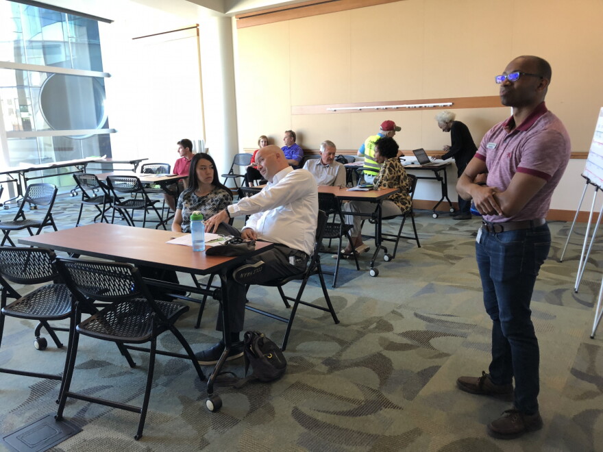 IndyGo Special Projects Coordinator Jerome Horne and community members await the Blue Line presentation at the Central Library Tuesday.