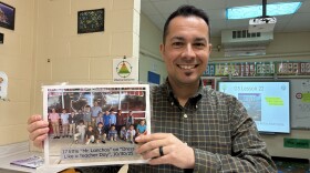 Jonathan Lancho holds up a photo of students dressed up as him for dress like a teacher day 