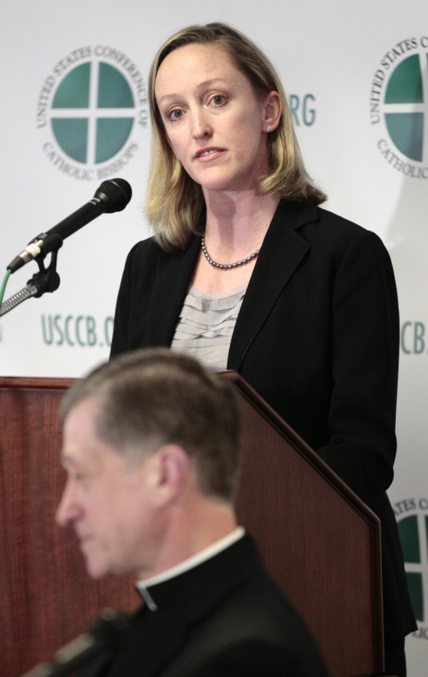 Karen Terry of the John Jay College of Criminal Justice and Bishop Blase Cupich of Spokane, Wash., are seen during a news conference by the U.S. Conference of Catholic Bishops to release the findings of a study analyzing the pattern of clergy sex abuse.