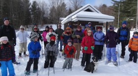 A group of winter adventurers enjoy a First Day hike in a Vermont State Park. 